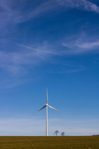 Windmill on field against sky