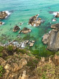 High angle view of rocks at sea shore