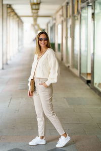 Portrait of young woman standing in city