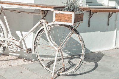 Bicycle wheel by wall