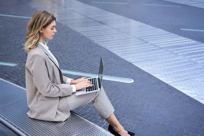 Portrait of young businesswoman using mobile phone