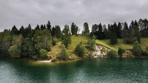 Scenic view of calm lake against trees