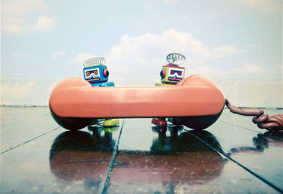 Close-up of toy car on table against sky
