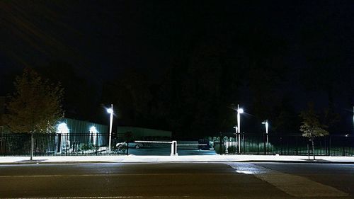 Illuminated lights against sky at night