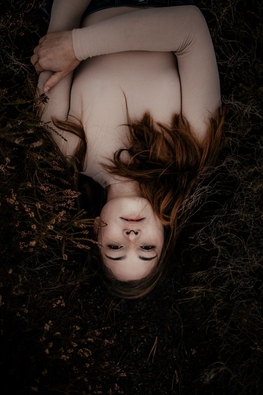 one person, real people, lying down, land, high angle view, field, lifestyles, young adult, leisure activity, lying on back, young women, hair, relaxation, eyes closed, women, hairstyle, directly above, nature, beautiful woman