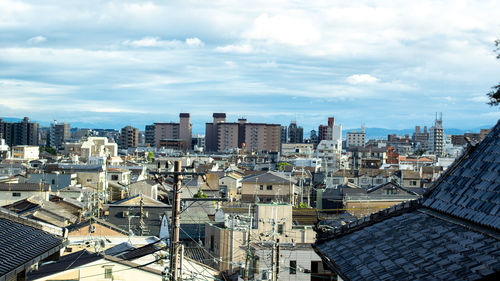 High angle view of buildings in city against sky