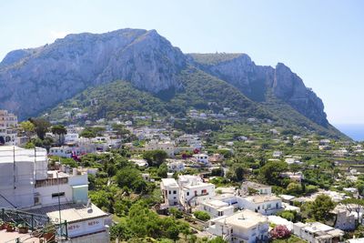 High angle view of townscape and mountains against sky