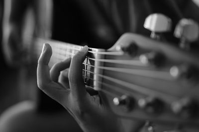 Close up of person playing guitar