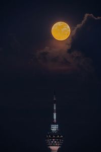 Low angle view of illuminated light against sky at night