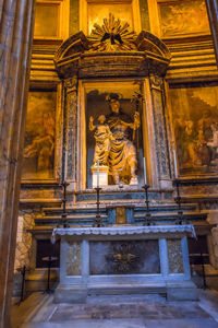 Low angle view of statue against historic building