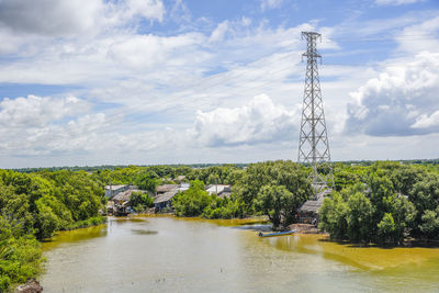 Plants by river against sky