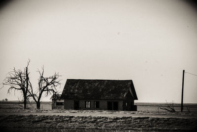 Abandoned built structure on landscape against clear sky