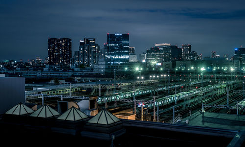 High angle view of illuminated buildings against sky at night