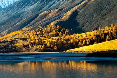 Scenic view of lake by mountains during autumn