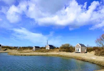 Scenic view of houses and buildings against sky