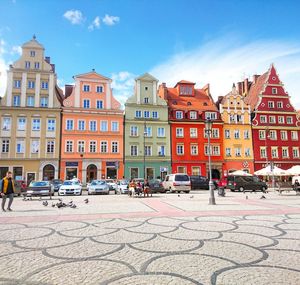 Colorful buildings in city against blue sky