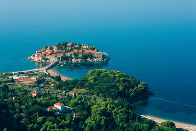 High angle view of sea and buildings against clear sky