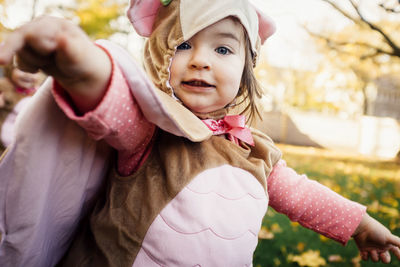 Portrait of cute baby girl wearing bird costume