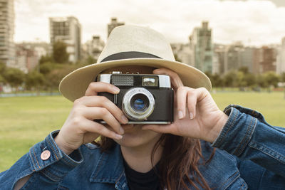 Close-up of woman photographing with camera