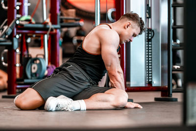 Full length of woman exercising in gym