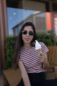 Portrait of a smiling young woman with ice cream