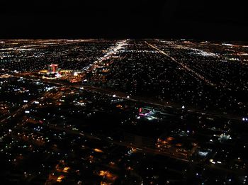 High angle view of city lit up at night