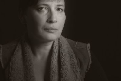 Close-up portrait of woman against black background