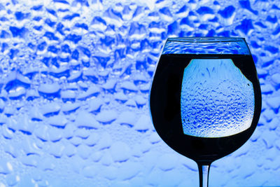 Close-up of drink on blue glass