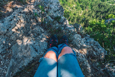 Low section of woman standing on rock