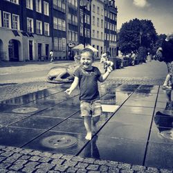 Full length portrait of woman standing in city