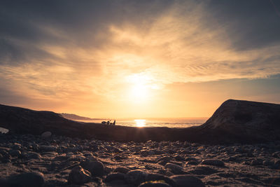 Scenic view of beach against sky during sunset