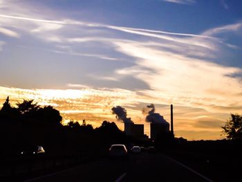 Cars on road at sunset