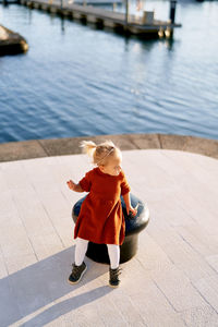 Rear view of girl on water