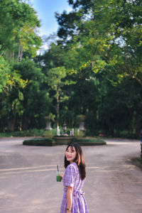 Portrait of young woman walking on street