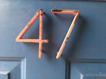 Close-up of number on blue wooden door