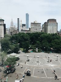 High angle view of city street and buildings against sky