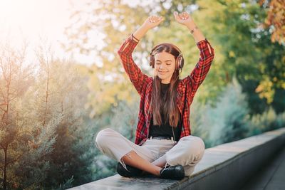 Portrait of smiling young woman sitting outdoors