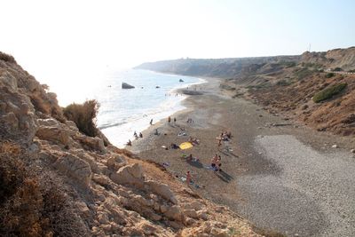 High angle view of people on beach against clear sky