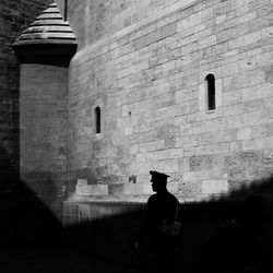 Silhouette of man in front of building