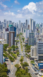 High angle view of street amidst buildings in city against sky