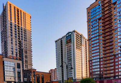 Low angle view of modern buildings against clear sky