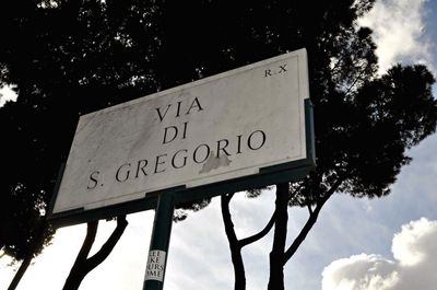 Low angle view of sign board against sky