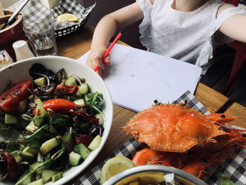 High angle view of woman preparing food on table