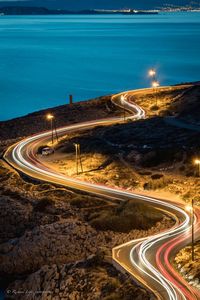 High angle view of light trails on road at night