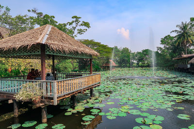 Built structure by lake against sky