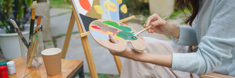 Midsection of woman painting