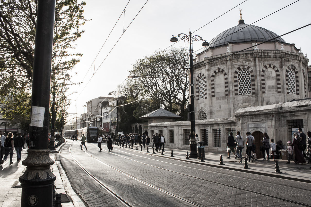 GROUP OF PEOPLE WALKING IN CITY STREET