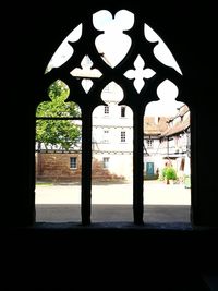 Illuminated trees seen through archway