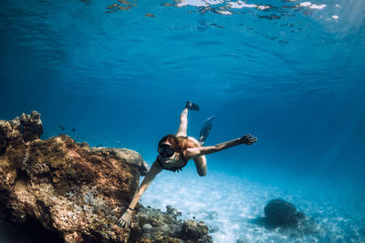 Young woman swimming in sea