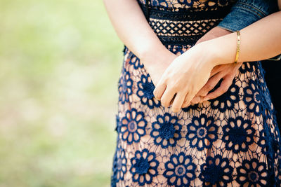 Midsection of woman standing against blurred background